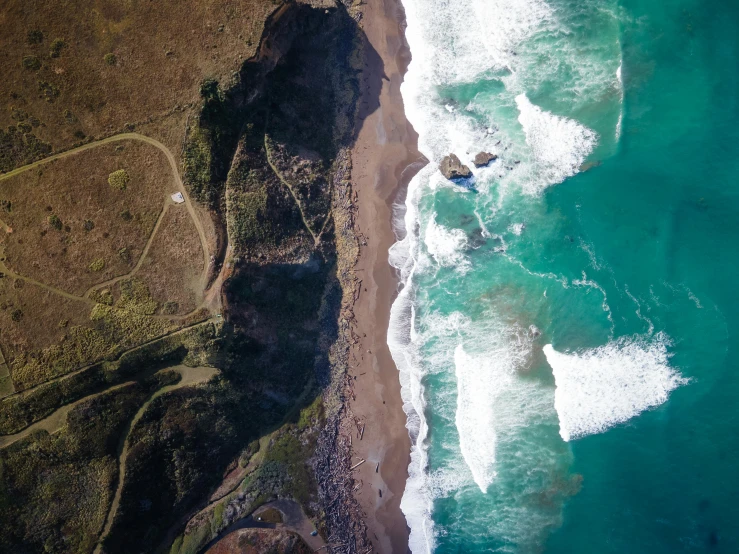 a bird's eye view of an area surrounded by cliffs and a body of water