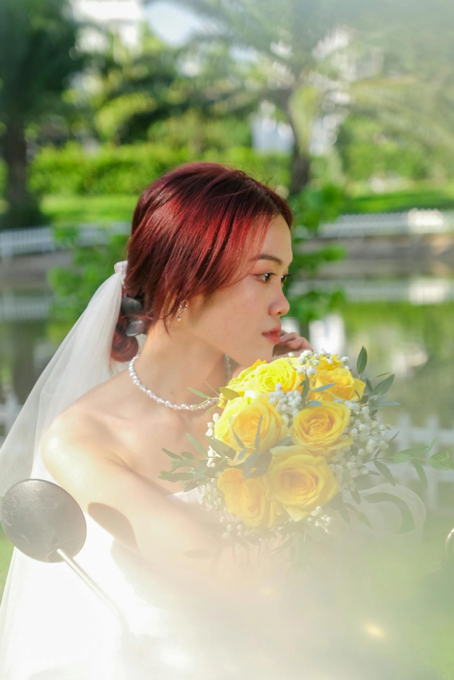 a bride posing for a po near the water