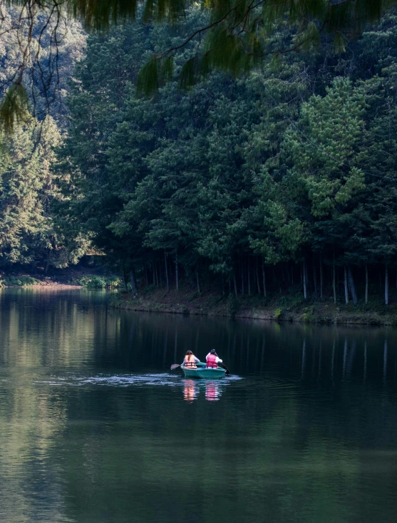 two people are out on the lake on their boats