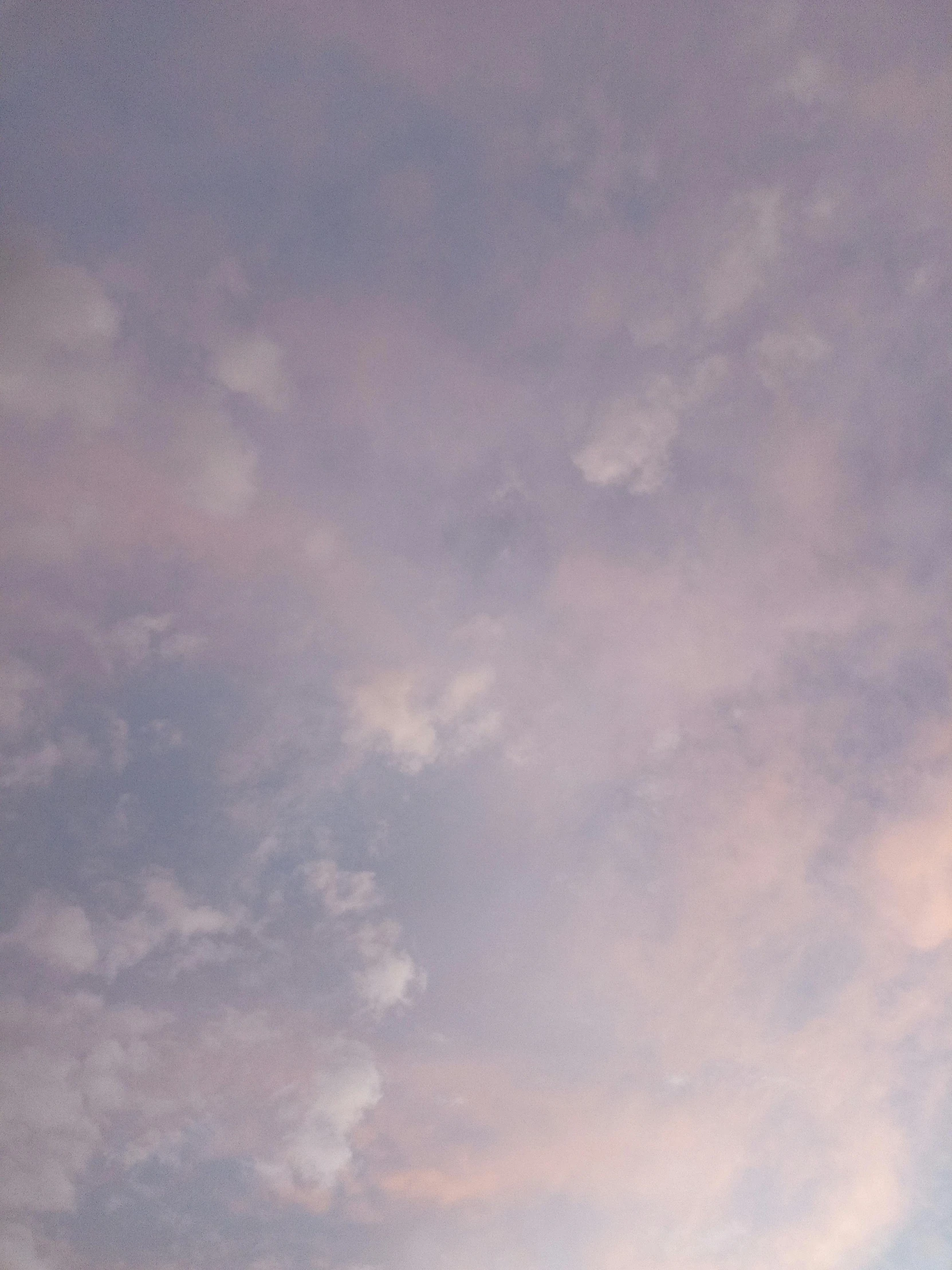 a large airplane flying through a cloudy sky