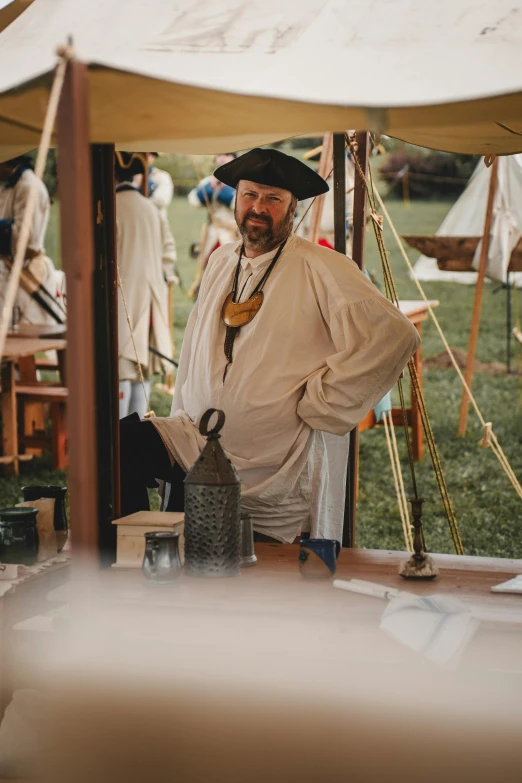 a man dressed in costume stands with an instrument