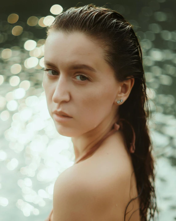 the woman is sitting in front of a body of water