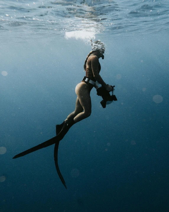 a woman is in the ocean, holding onto a piece of equipment