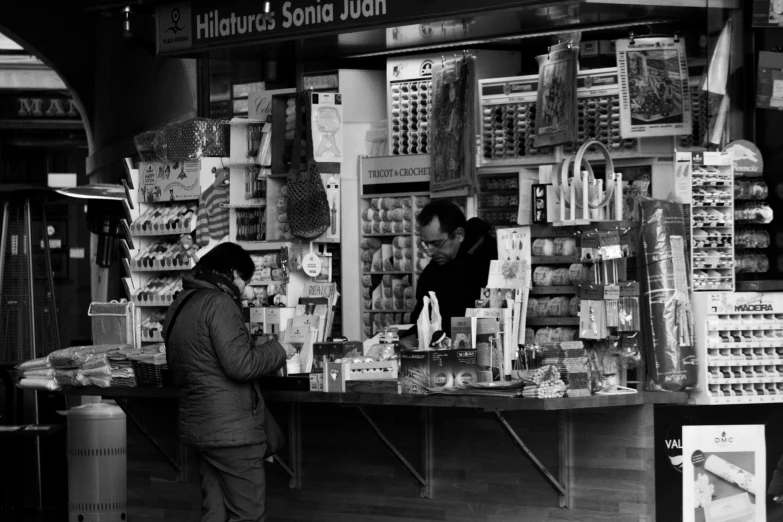 an old po of a person sitting in front of a store