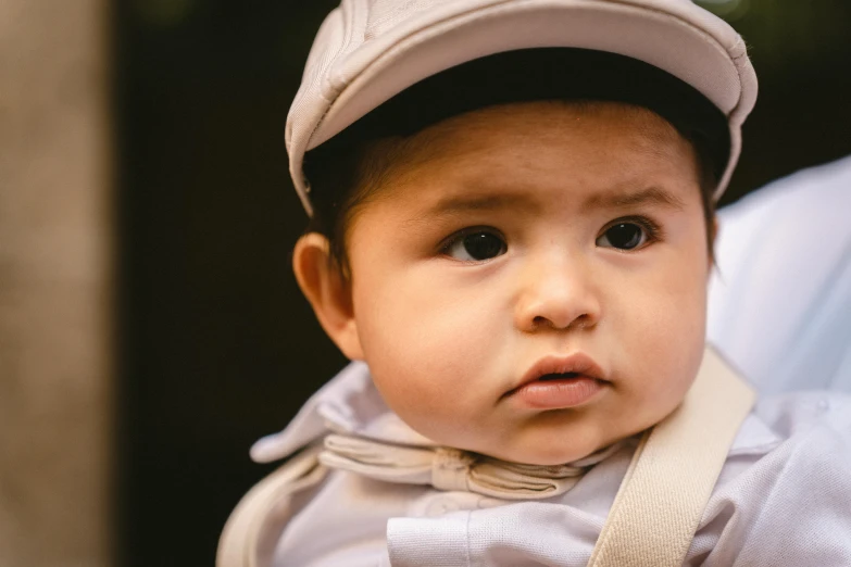 an infant boy wearing a hat and scarf