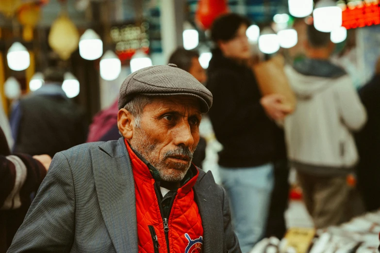 a man standing in a crowd near other people