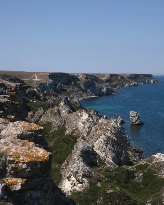 an ocean view with cliffs next to water