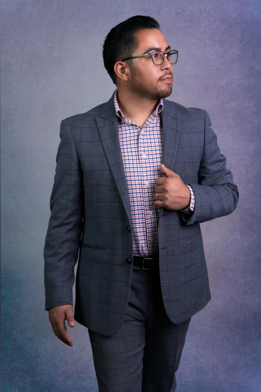 a man in a suit is standing in front of a camera