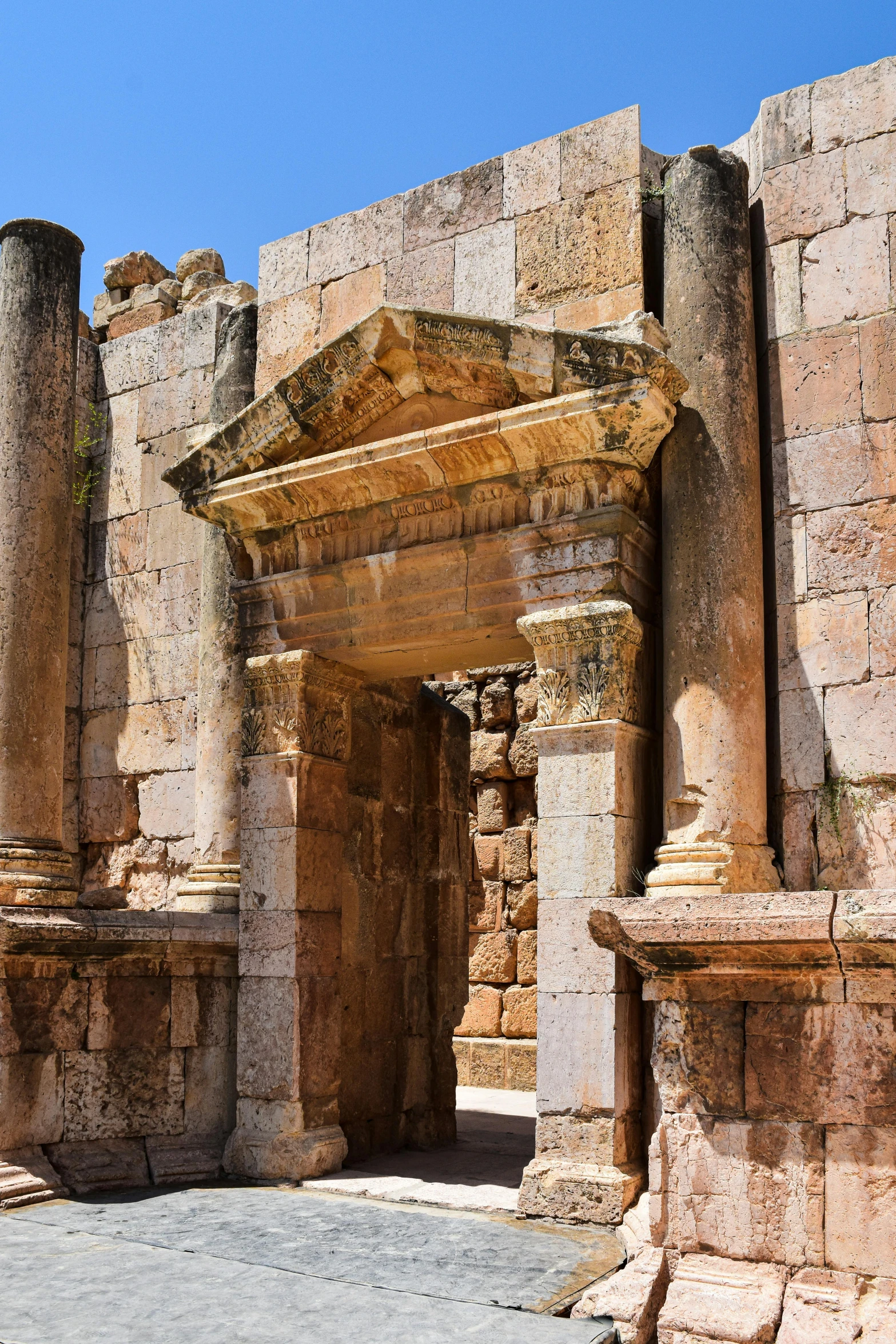 stone building on cement floor with pillars and columns