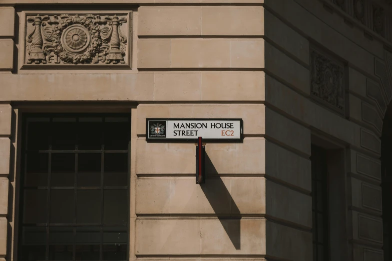 a street sign hangs on a building in a foreign country