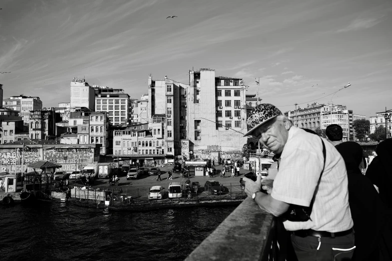 a man looking at his phone with buildings and a city in the background