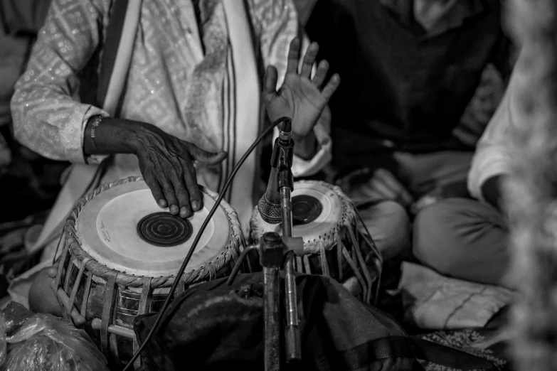 a man that is sitting down playing a drums