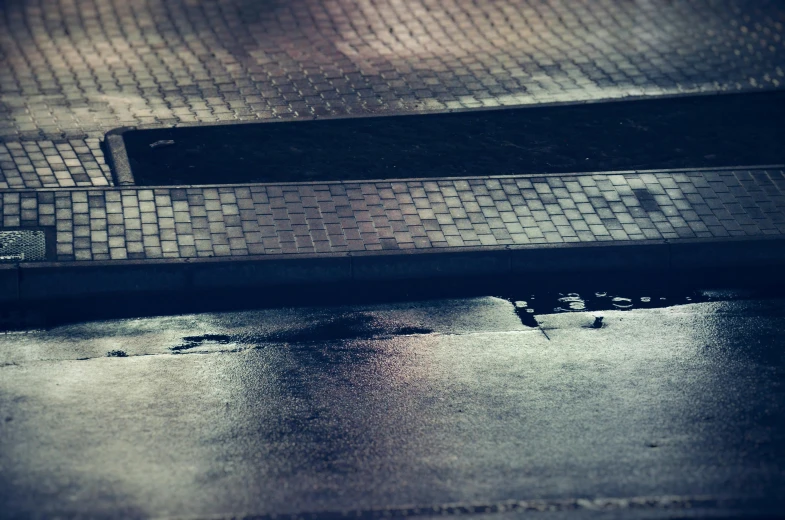 a close up image of a street area with a metal bench