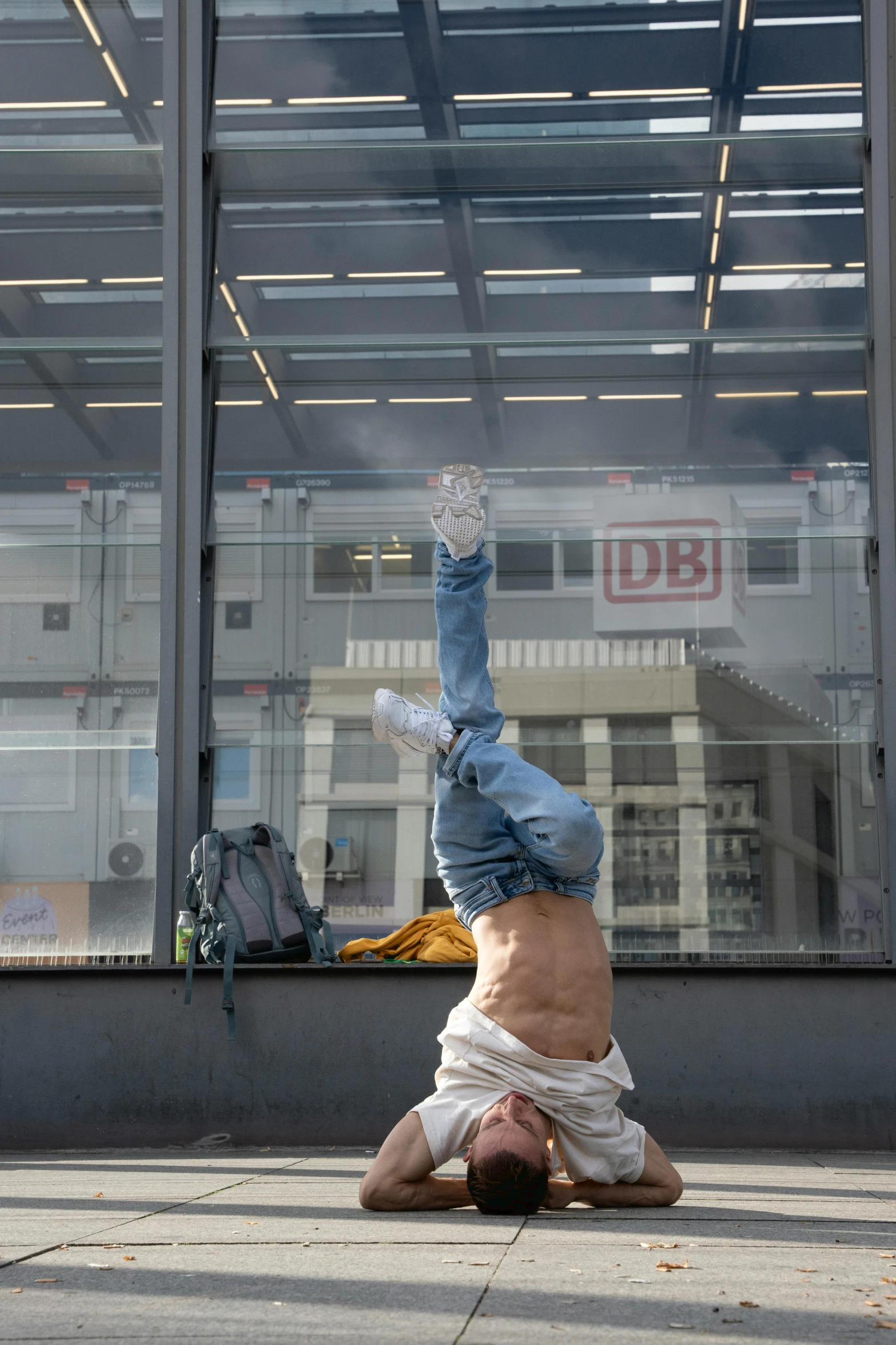 the man in jeans is doing a handstand