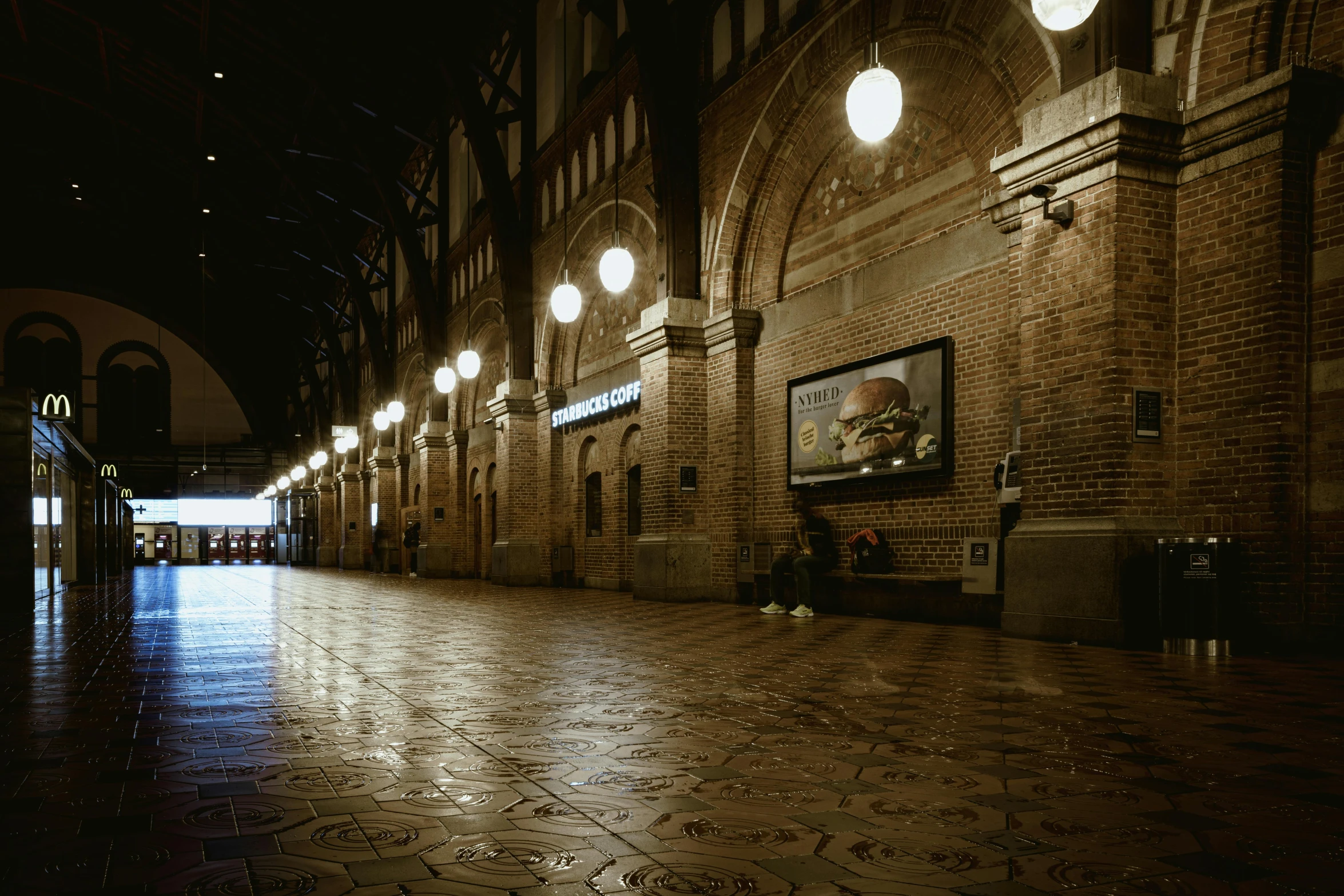 an empty and dark city street at night with many lights