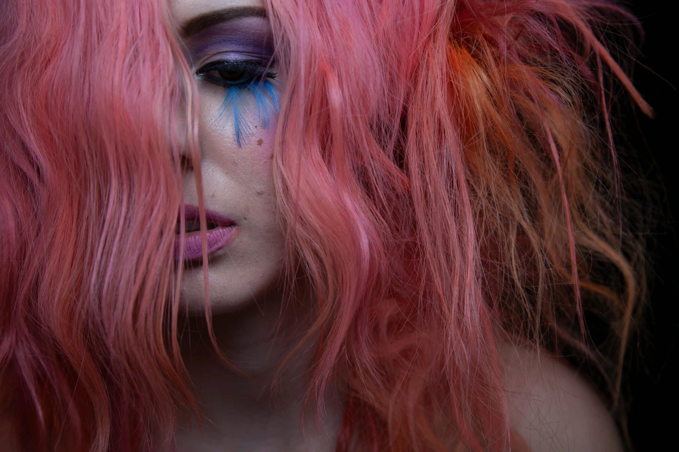 a close - up image of a female with dyed hair