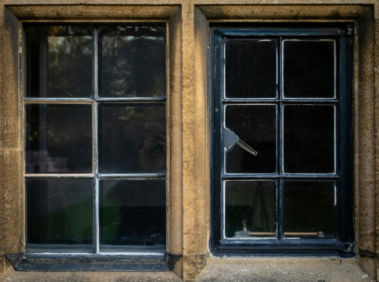 a building with three windows on one and some glass