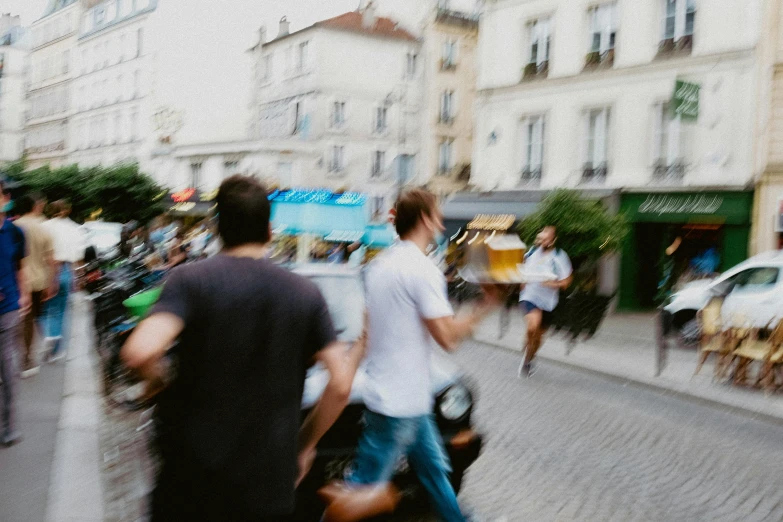 blurred image of pedestrians walking in a town square