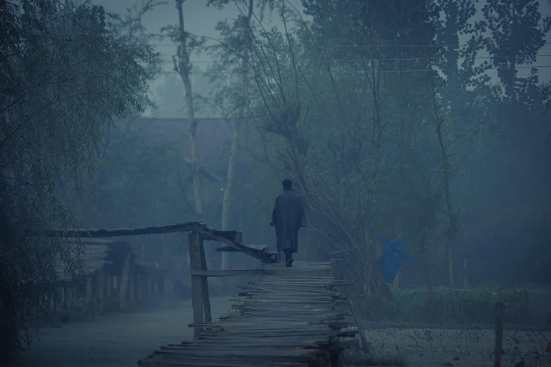 a man is walking alone through the forest