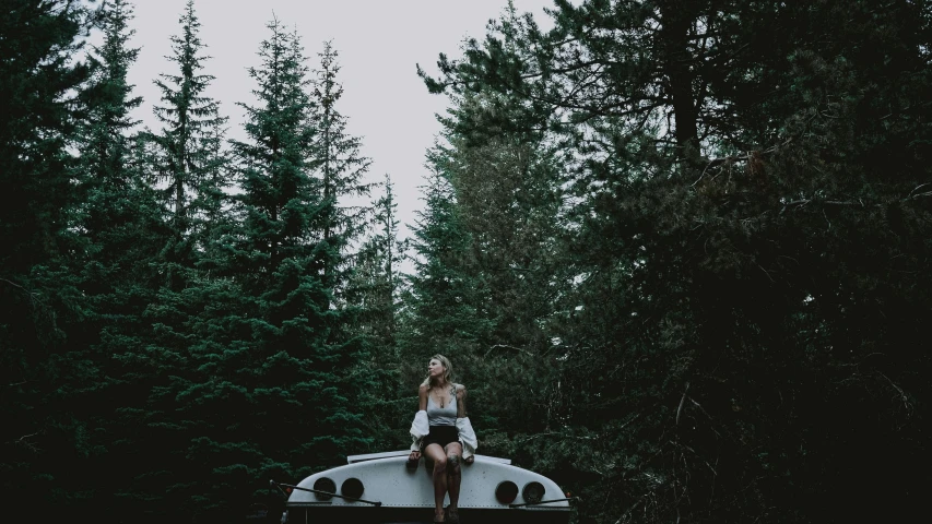 a girl sitting on the back of a truck