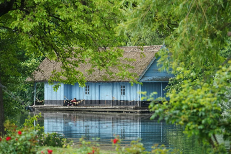 a building sitting on top of a river surrounded by trees