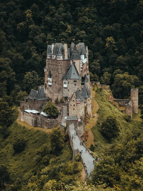 this castle is surrounded by some trees and rocks