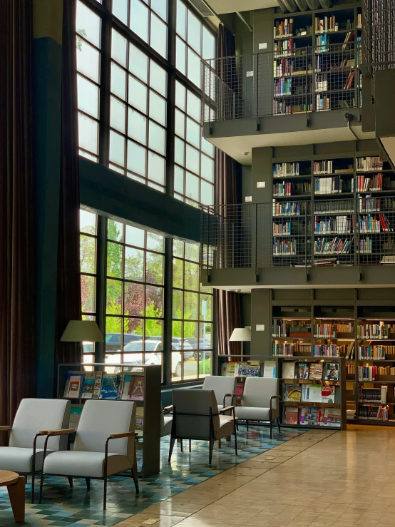 the large reading area has several chairs and shelves of books