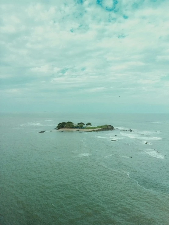 a body of water with an island in the background