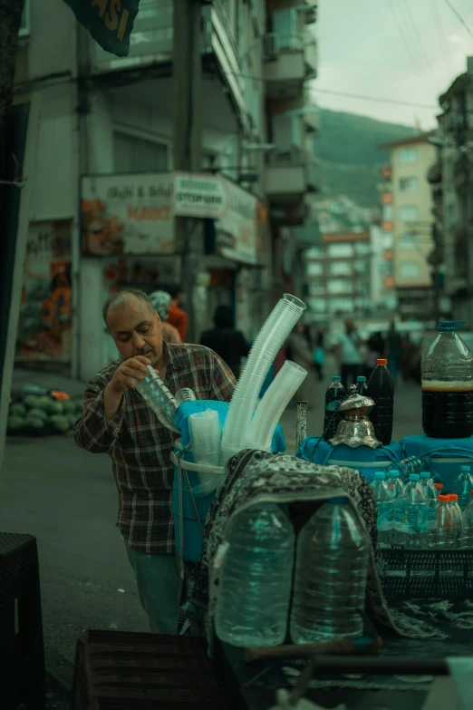 a man is looking at a blue table holding objects