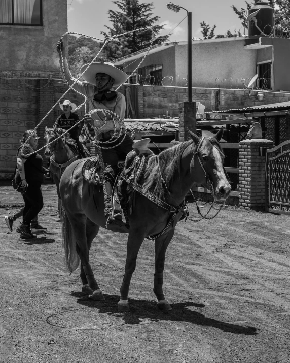 black and white pograph of two men on horses