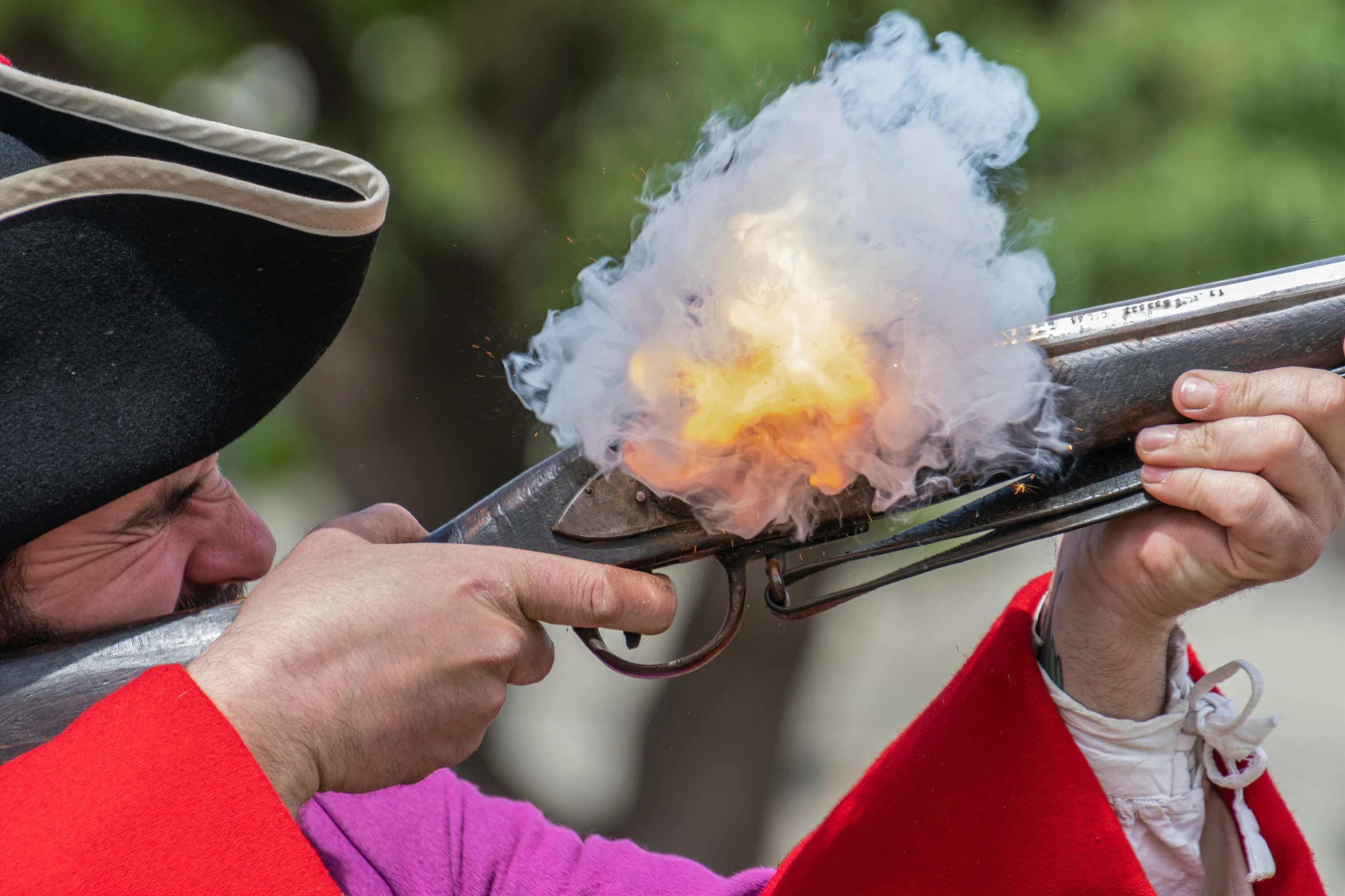 a man holding a gun with smoke coming out of it