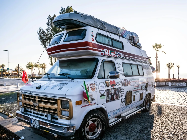 a white truck that has an rv on top