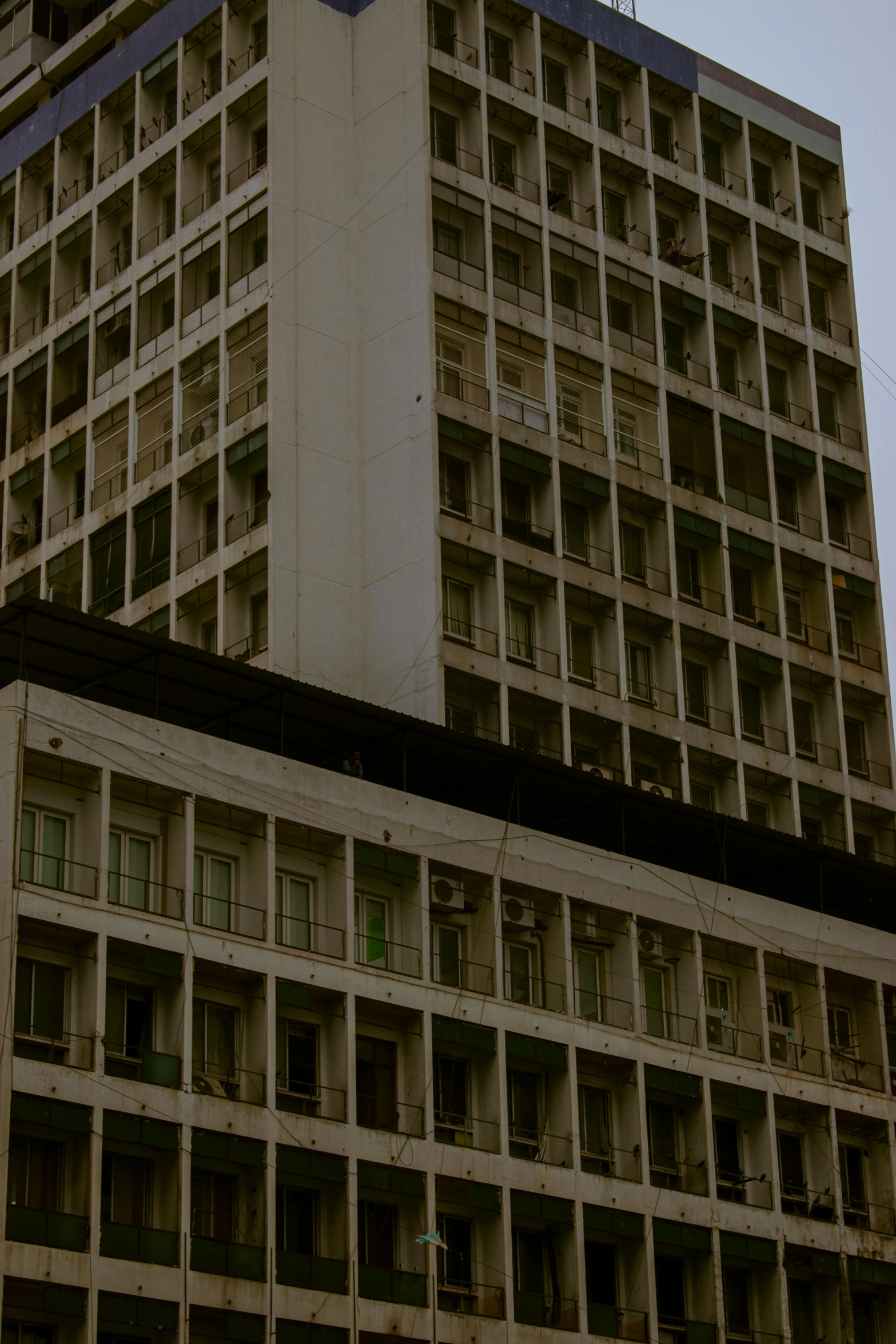 the tall building is surrounded by windows in several sections