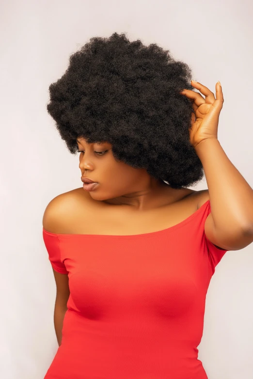 a woman with a big afro in a red dress