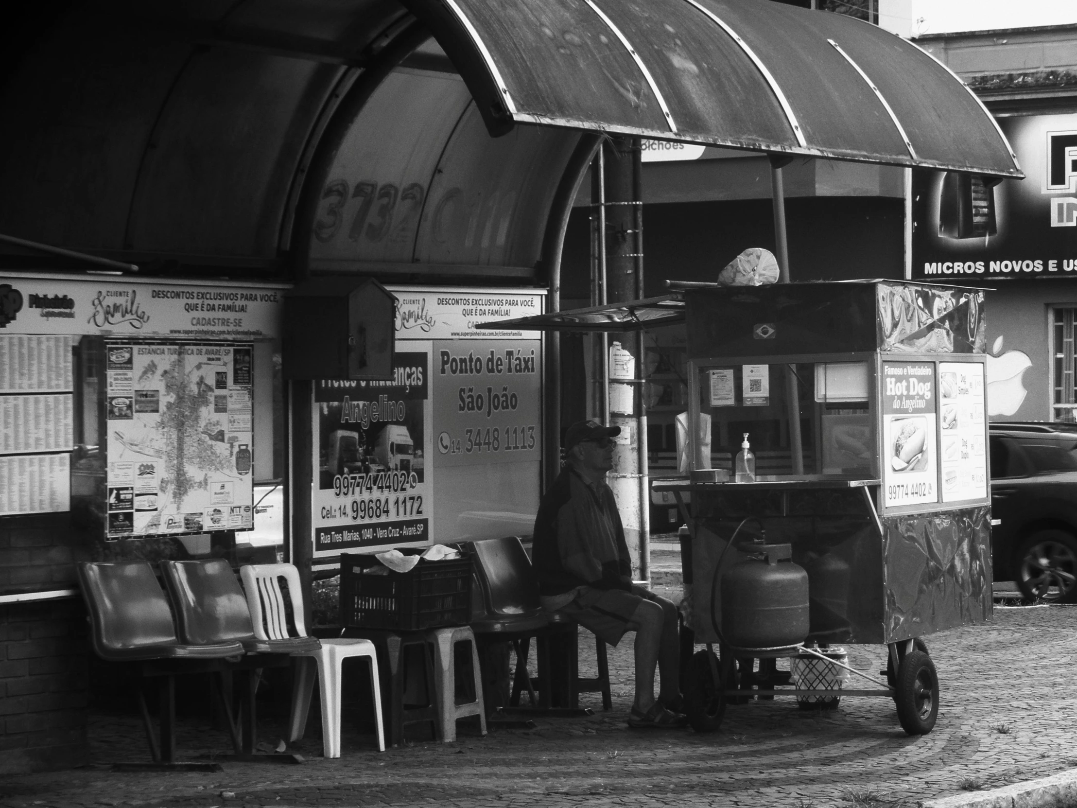 a black and white image of some people outside a store