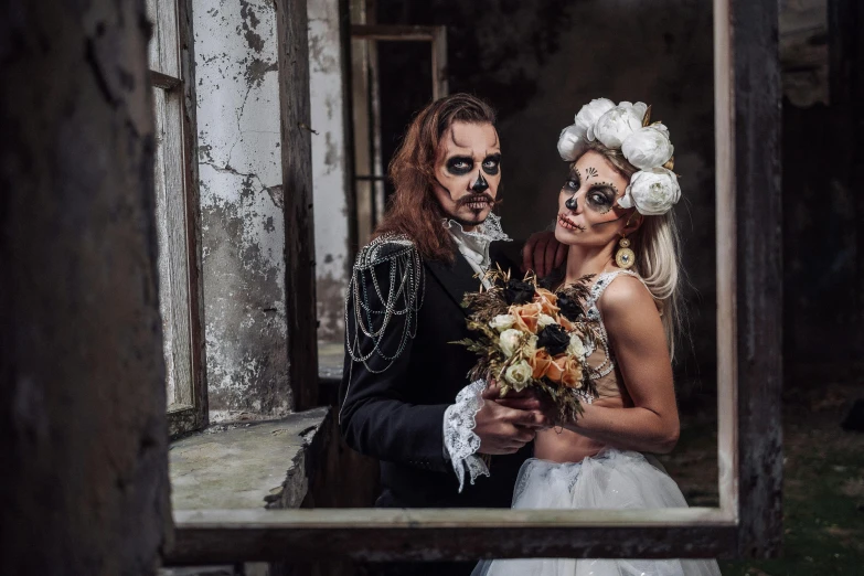 a man and woman are wearing costume with their faces painted like flowers