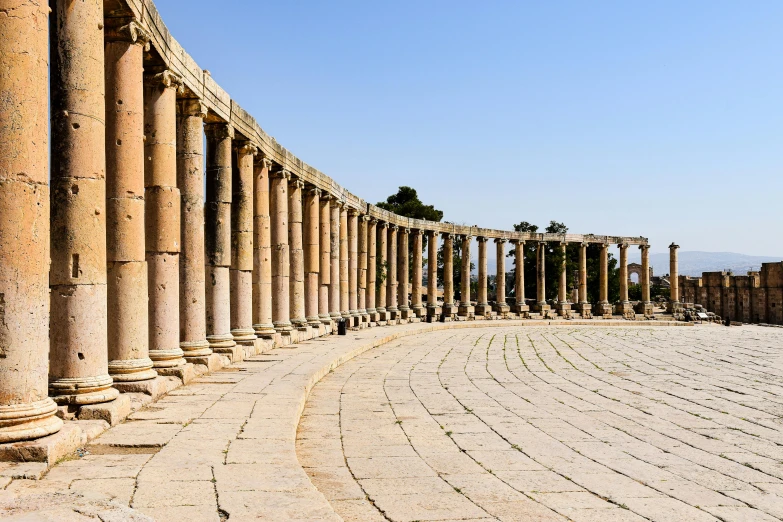 there is a very long row of pillars that line the building