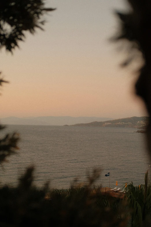 a view from an overlook in front of a body of water and mountains