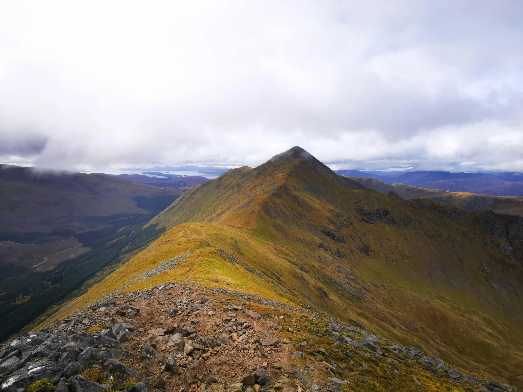 an image of a mountain range with rocks and grass