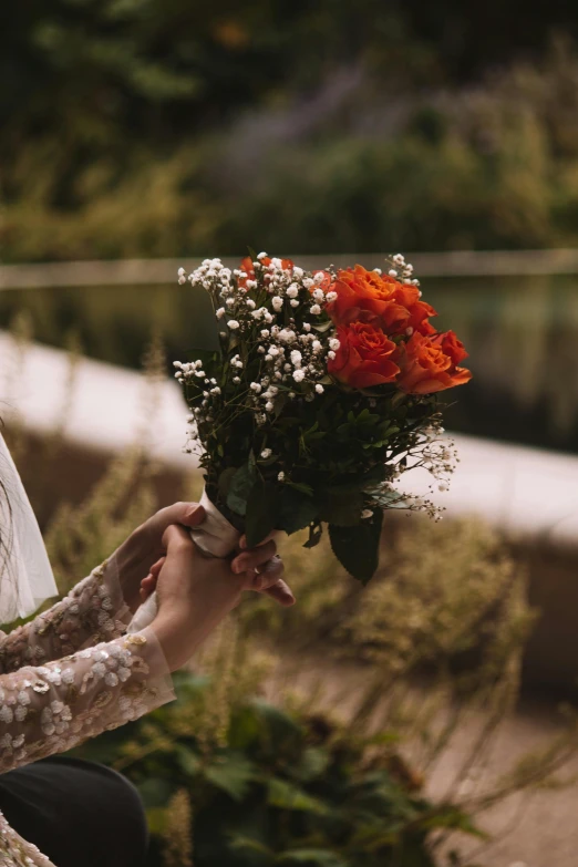 there is a woman holding a bouquet in her hand