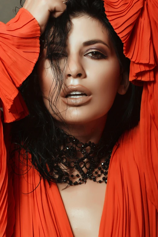 an extremely beautiful lady in red posing with her hands up