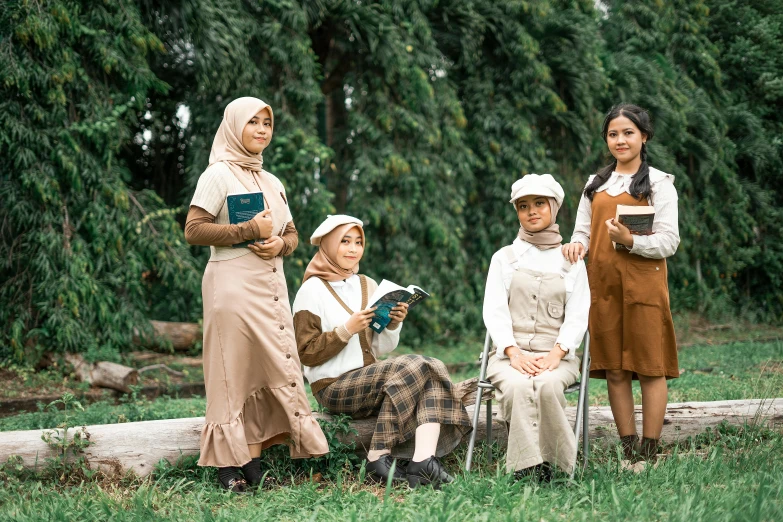 four women are posing for a pograph while reading