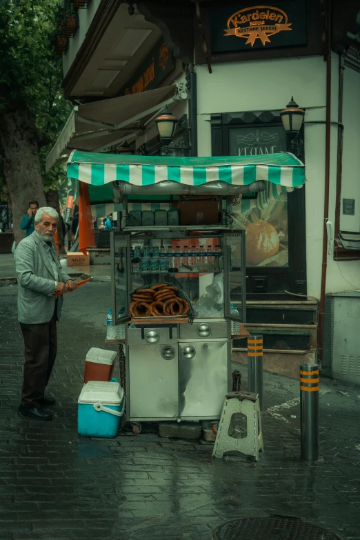 a man is standing next to a street vendor