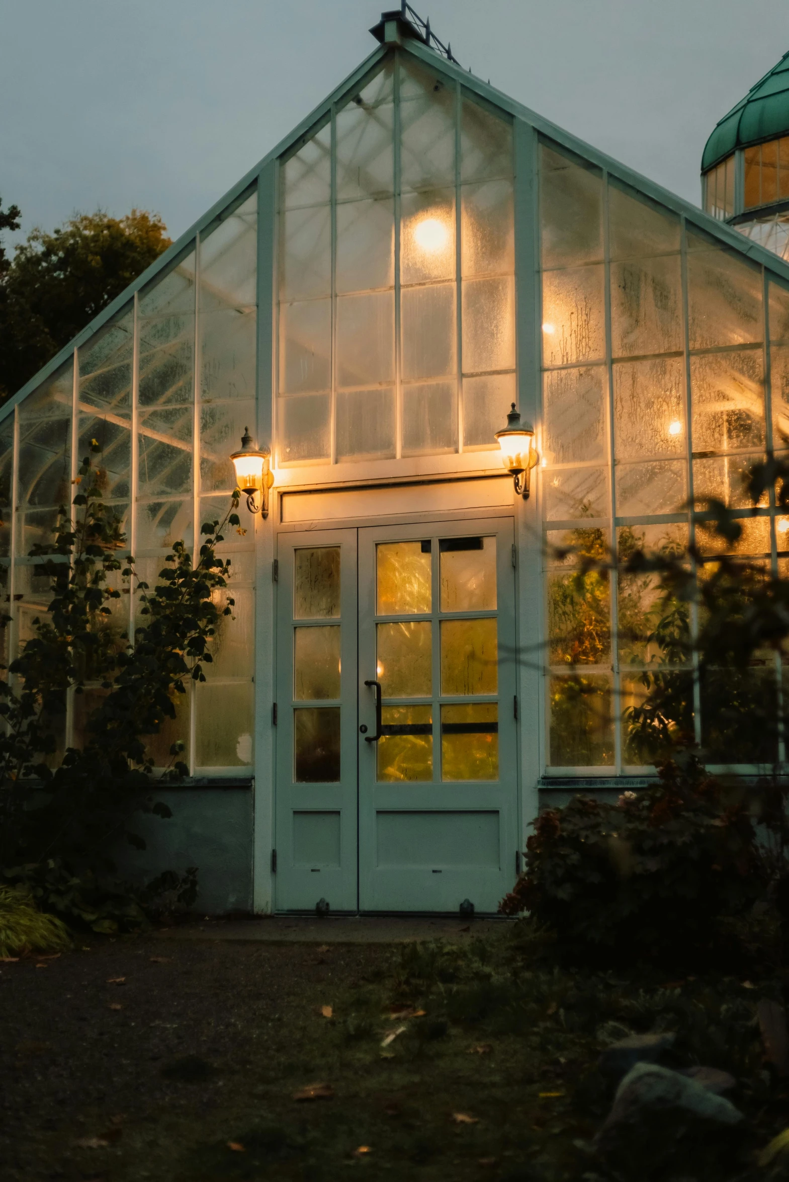 a glass house with some windows and lights on it