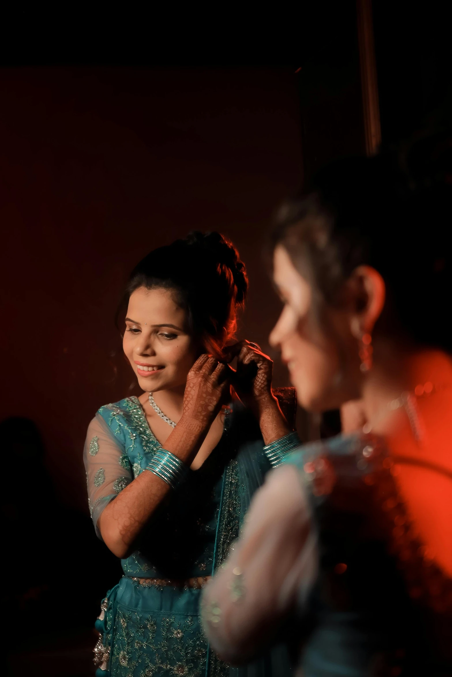 two women are posing for a picture in the dark