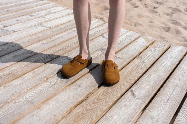 a person with very short legs standing on a pier