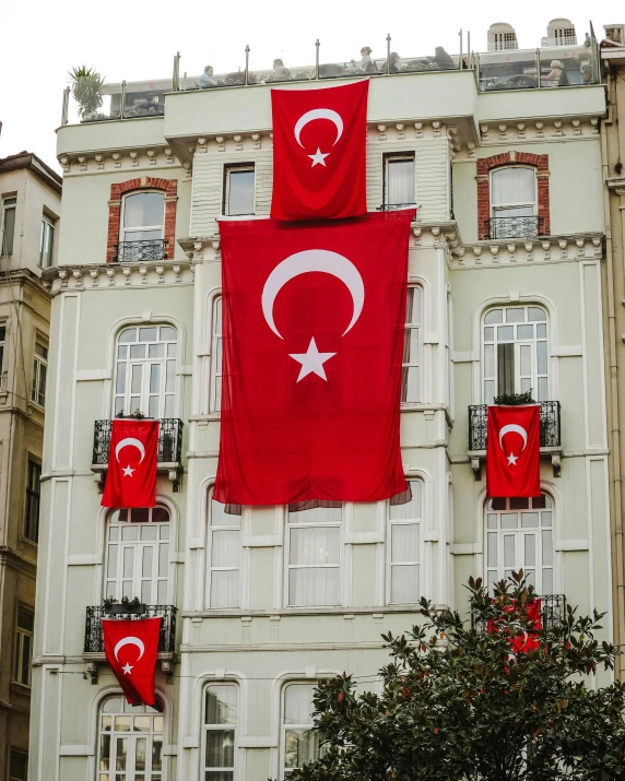 the building has several flags on the sides