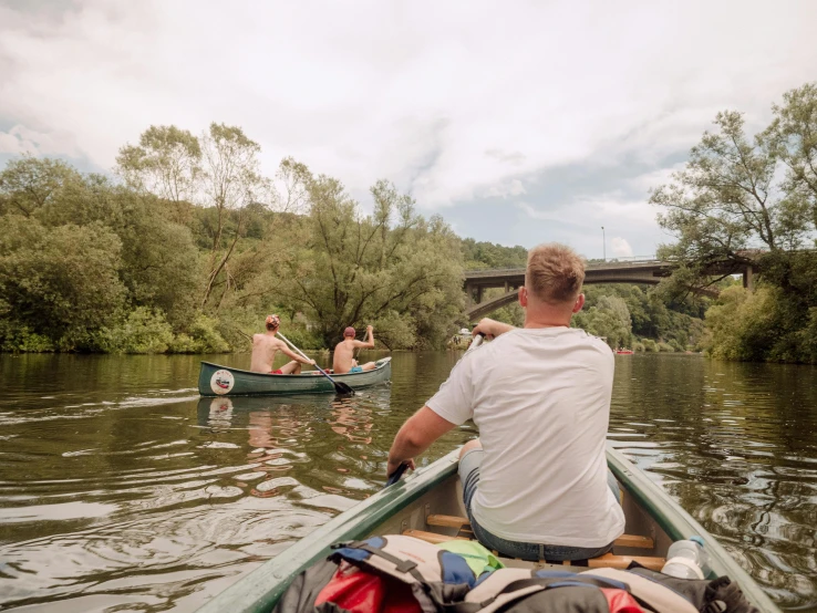 a man and woman rowing a canoe in a river