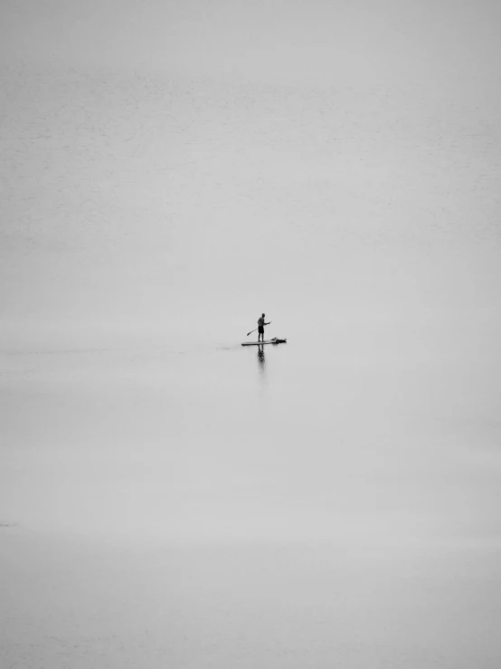 a person standing on a surfboard in a body of water