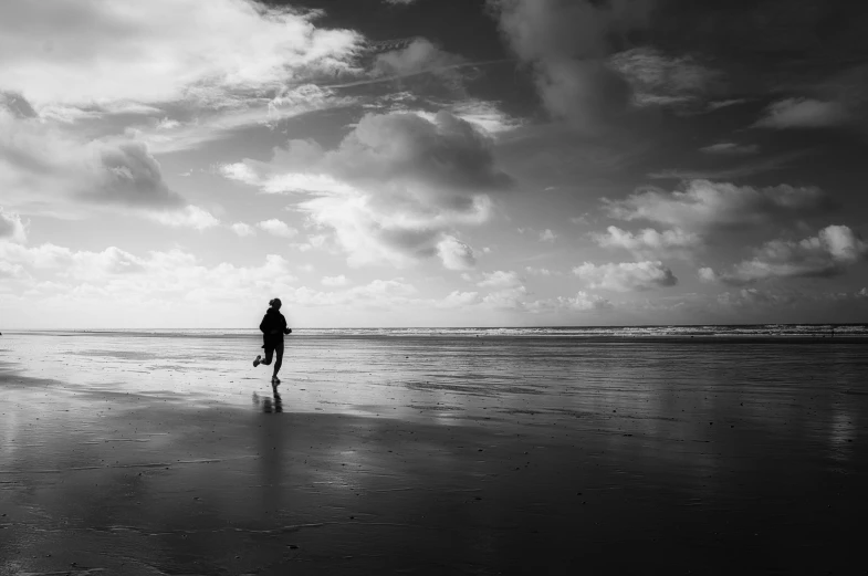 a person is standing on the beach alone